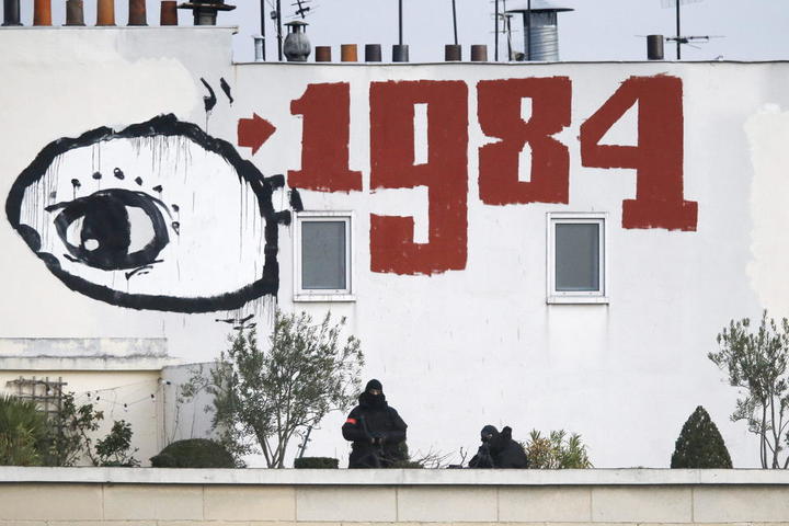 epa04558643 (FILE) A file photograph showing snipers taking up position at the top of a building under the graffiti of an eye and the mention of 1984 at the Place de la Nation finishing point of a march to honor the victims of the terrorist attacks and to