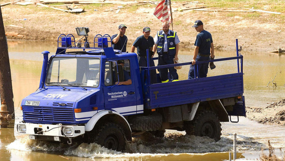 A crew from the German organization Technisches Hilfswerk ride in a four-wheel drive vehicle through flood waters Wednesday, 28 September 2005 in New Orleans, Lousiana.The levees around the city failed due to the storm surge caused from Hurricanes Katrina